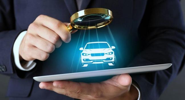 Проверка и оценка автомобиля Мужчина с лупой в руках смотрит на машину